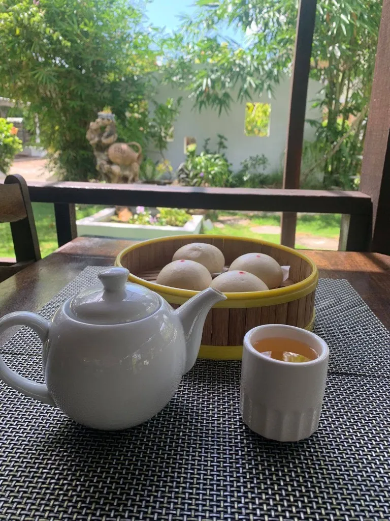 Tea and steamed buns on a garden table